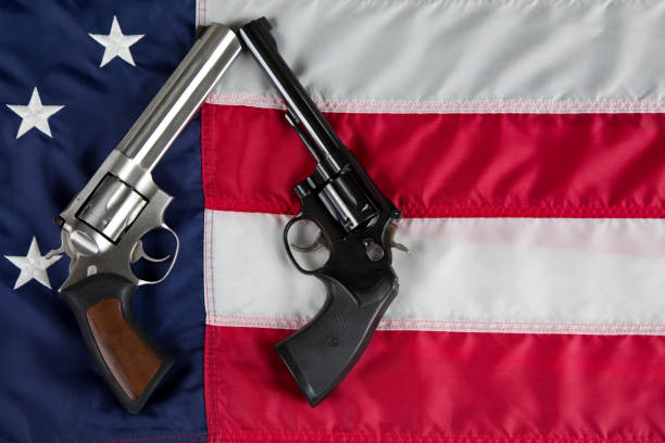 istock Revolvers lying on American Flag background 1802456639