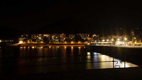 Lekeitio town night view from pier. Basque autonomous community, Spain.