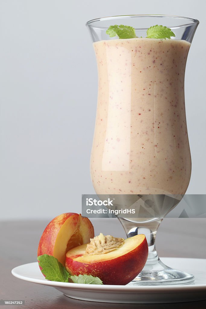 Nectarine milk shake Fresh nectarine milk shake in a glass Cocktail Stock Photo