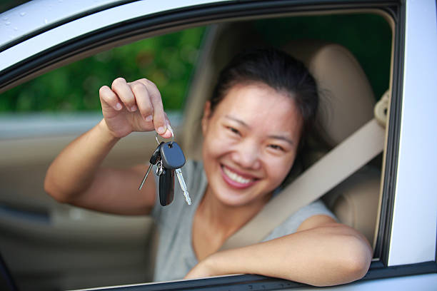 istock happy woman driver with her new car 180247358