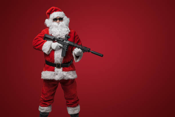 istock Festive Santa Claus with Toy Rifles 1802487624
