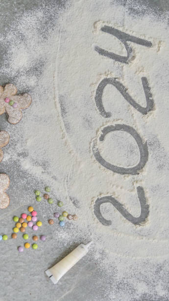 istock a child's hand draws 2024 in flour 1802489243