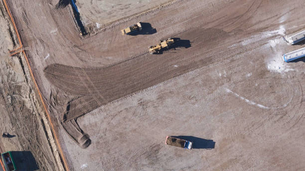 istock Earthmoving equipment. Aerial view of a large construction site with several earthmoving machines. 1802491529