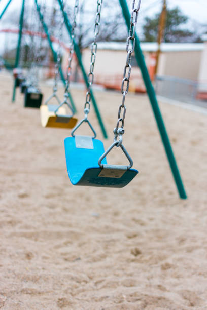 istock A row swings on a playground 1802509947