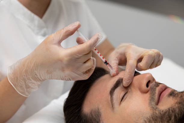 istock Cosmetologist making mesotherapy injections to mans face 1802509949