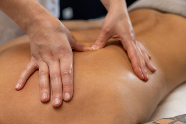 istock Close up of massage therapist hands doing back massage 1802510500