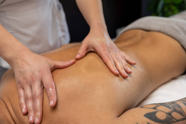 istock Close up of massage therapist hands doing back massage 1802510507