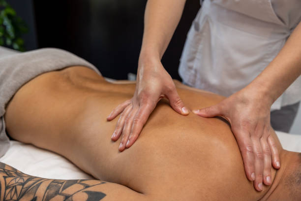 istock Close up of massage therapist hands doing back massage 1802510522