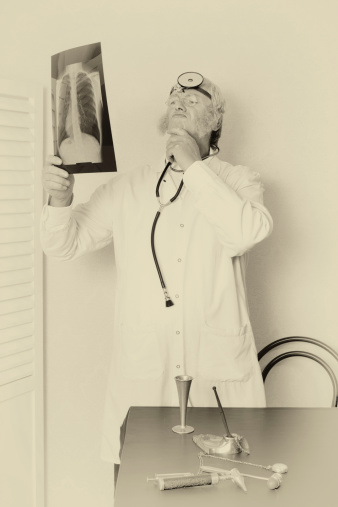 Old faded effect on a vintage doctor examining an x-ray