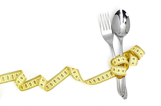 istock Steel spoon a fork and measuring tape 180251155