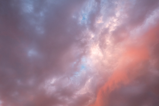 A beautiful sunset sky with clouds, nature landscape with pink, purple, and blue colors.
