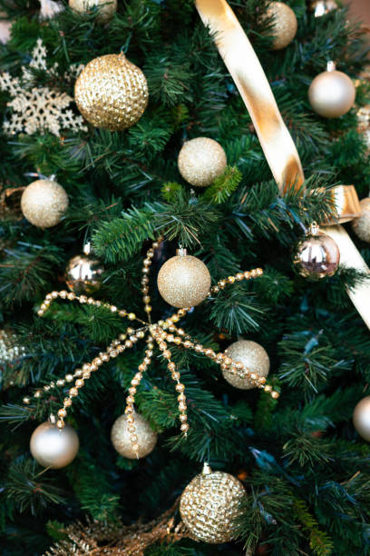 istock Gold ornaments on a Christmas tree 1802529349