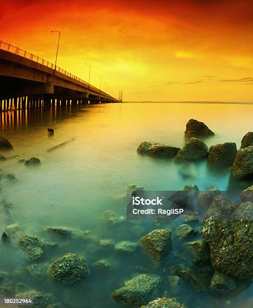 Suramadu Bridge Beside Rocks Stock Photo - Download Image Now - Architecture, Backgrounds, Beach