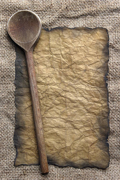 istock Wooden spoon and old paper 180253279
