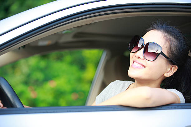 istock happy woman driver driving her car 180253376