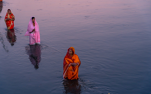 An ancient Hindu festival, dedicated to Lord Surya and Chhathi, A devotee offers prayers to the setting sun during the “Chhath” festival at Bagmati River  in Kathmandu, Nepal, on  Sunday November 19, 2023