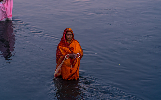 An ancient Hindu festival, dedicated to Lord Surya and Chhathi, A devotee offers prayers to the setting sun during the “Chhath” festival at Bagmati River  in Kathmandu, Nepal, on  Sunday November 19, 2023