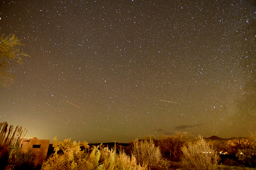 Ojo Caliente NM, USA-  November 18, 2023: Not long after the sun has set, the Stars, Galaxies and Planets become visible. Twilight is the time between Day and Night. The Mountains and Forests of New Mexico  provide the foreground.