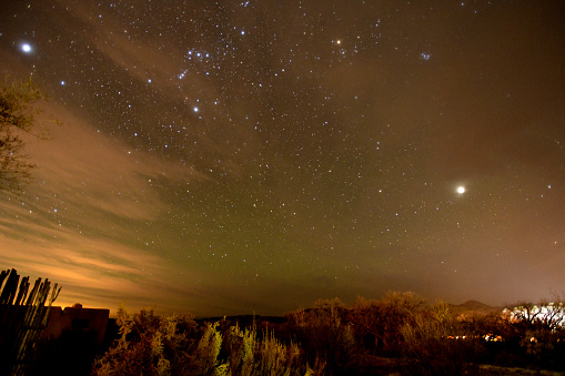 Ojo Caliente NM, USA-  November 18, 2023: Not long after the sun has set, the Stars, Galaxies and Planets become visible. Twilight is the time between Day and Night. The Mountains and Forests of New Mexico  provide the foreground.