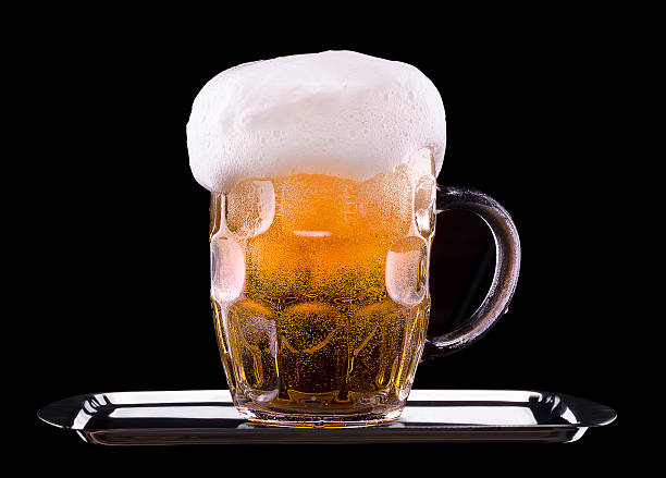 istock Frosty glass of light beer on black background 180255642
