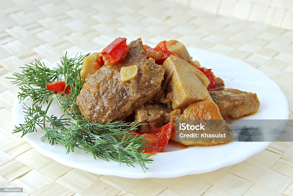 meat stewed with cepes meat stewed with cepes with a fennel branch on a white plate Beef Stock Photo