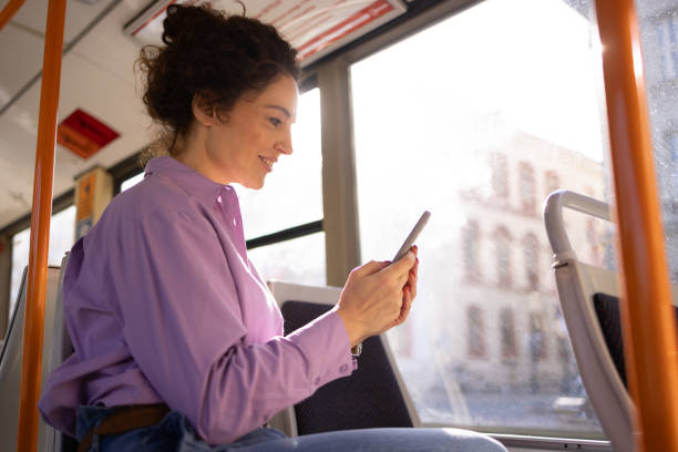 istock Woman using mobile phone in bus 1802565588