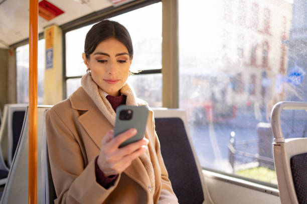 istock Woman using mobile phone in bus 1802567431