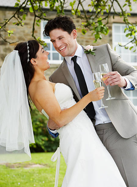 istock Bride And Groom Drinking Champagne At Wedding 180256979