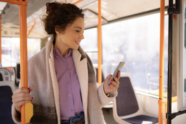 istock Young woman traveling by bus and using smart phone 1802573061