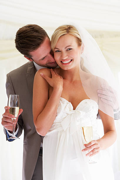 istock Bride And Groom Drinking Champagne At Wedding 180257991