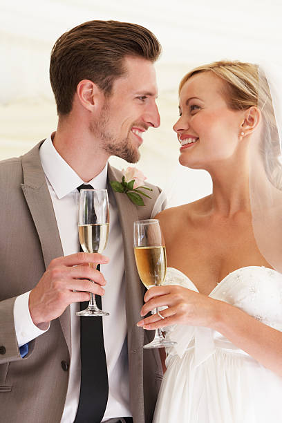 istock Bride And Groom Drinking Champagne At Wedding 180258033