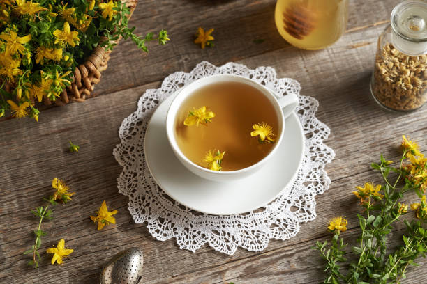 istock Fresh St. John's wort flowers in a white ceramic cup of tea 1802588172
