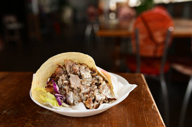 close up of kebab sandwich on wooden background