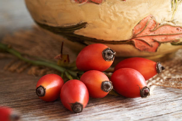istock Fresh rosehip berries on a wooden table 1802594686
