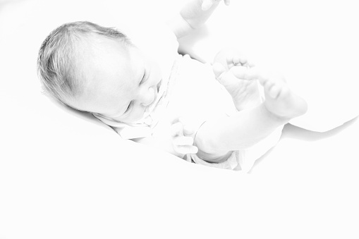 Overexposed black and white new born baby photo. Beauty, new life, family, love concept.