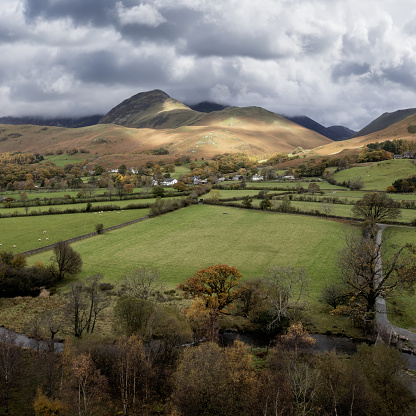 buttermere village and grasmoor in the lake district with buttermere dubs stream in the foreground