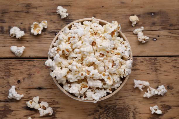 istock Tasty popcorn on wooden table, flat lay 1802626030