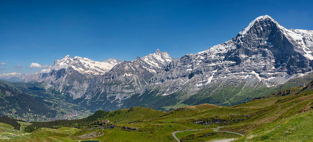 the mountains eiger schreckhorn and wetterhorn above grindelwald village in the bernese oberland sunny day blue sky panorama