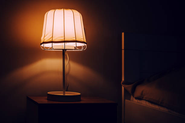 istock Nightstand bedside lamp in bedroom at night 1802637820