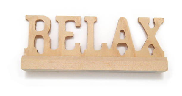 istock RELAX word - in letterpress wood block on white background 1802639963