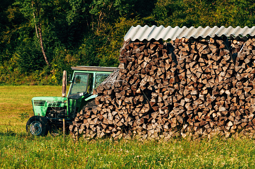 Chopped firewood stack on farm, drying for winter season, selective focus