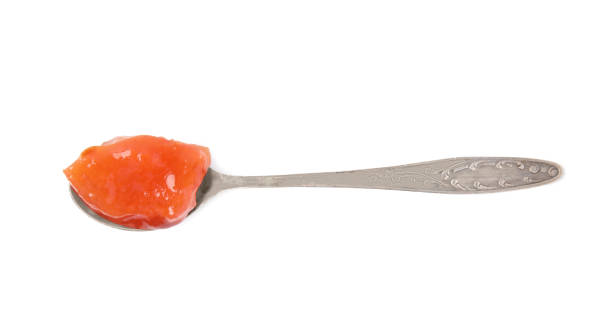istock Spoon with tasty persimmon jam isolated on white, top view 1802662979