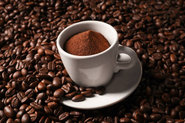istock Cup with ground coffee on roasted beans 1802673651