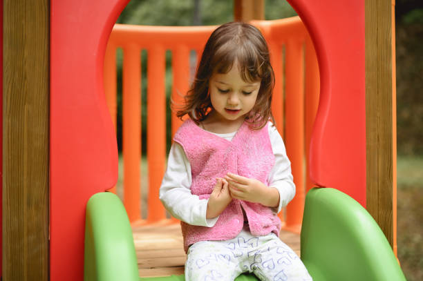 portrait of a cute toddler using slide.