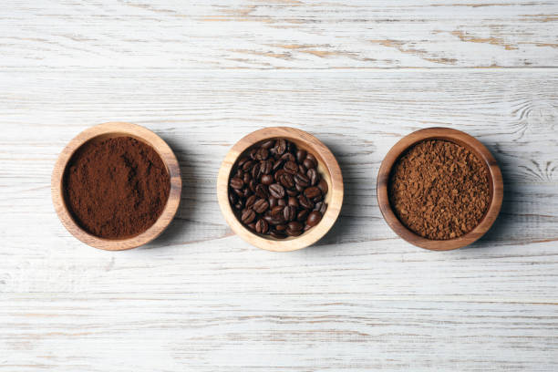istock Instant, ground coffee and roasted beans on white wooden table, flat lay 1802675774