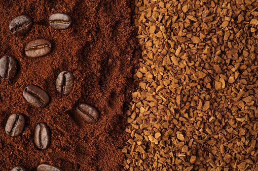 Instant and ground coffee, roasted beans as background, top view