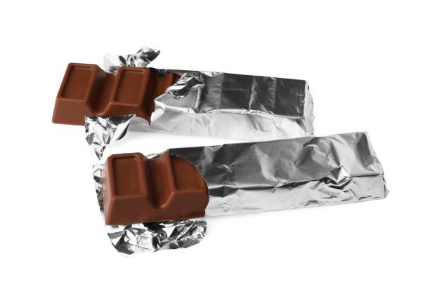 istock Delicious chocolate bars wrapped in foil on white background 1802678467