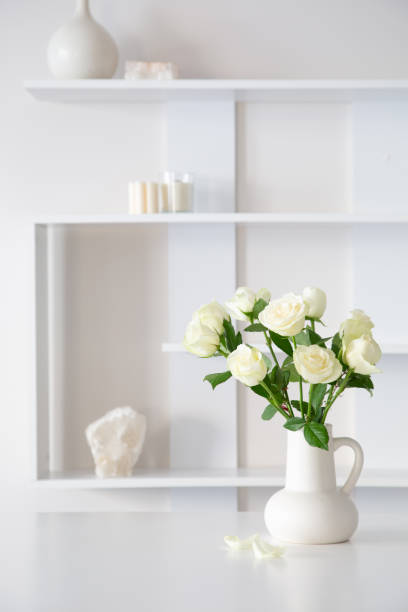 istock white roses in white jug in white interior 1802682828
