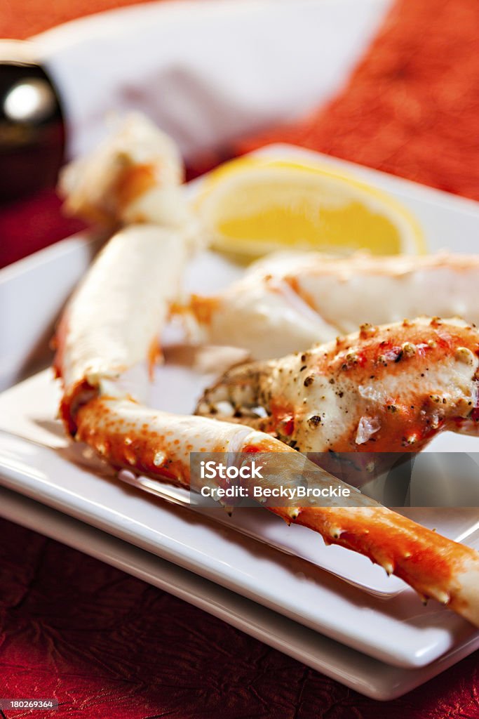 King Crab Legs King crab legs, lemon, and napkin photographed in studio setting Alaskan King Crab Stock Photo