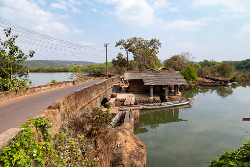 This image highlights the Char Manos Heritage Culvert, a lesser-known yet historically significant structure located in Goa, India. The culvert, characterized by its aged stone construction, stands as a relic of Goa's past, showcasing the region's old engineering and architectural practices. In the photograph, the culvert is captured amidst lush greenery, representing a blend of natural beauty and historical intrigue. The image aims to bring attention to this hidden gem, emphasizing its rustic charm and the quiet story it tells of a bygone era in Goan history. The Char Manos Heritage Culvert serves not just as a functional structure but as a symbol of the rich cultural and historical tapestry that defines Goa.